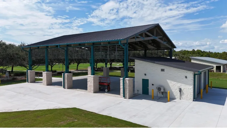 Steel canopy and service building construction project in Panama City, FL with new concrete pad and metal roof