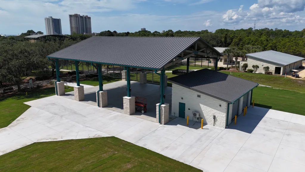 Construction project in Panama City, FL featuring a metal-roof pavilion and utility building with concrete pad