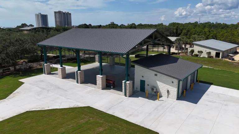 Construction project in Panama City, FL featuring a metal-roof pavilion and utility building with concrete pad
